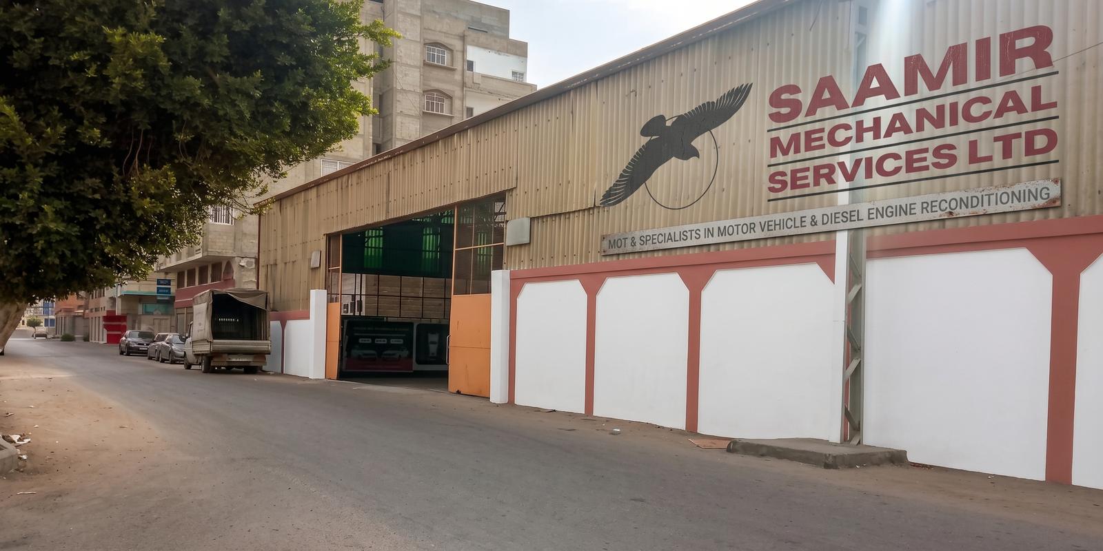 The Saamir Mechanical Services building on Omar Al Mukhtar Street, Gaza, with the falcon emblem and company sign on the façade.